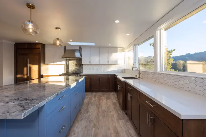 In the custom cabinets vs. stock debate, consider the quality you want. This kitchen features blue and wood-tone cabinets.