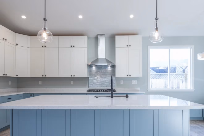 A kitchen island with pendant lights above it.