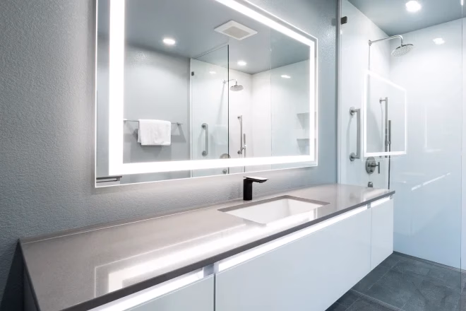 A stunning floating vanity with an offset sink and LED vanity lighting