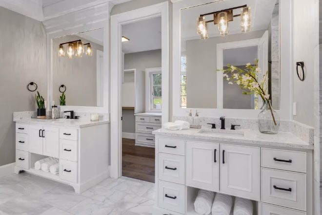 Beautiful bathroom in new luxury home with two vanities, sinks, and mirrors.