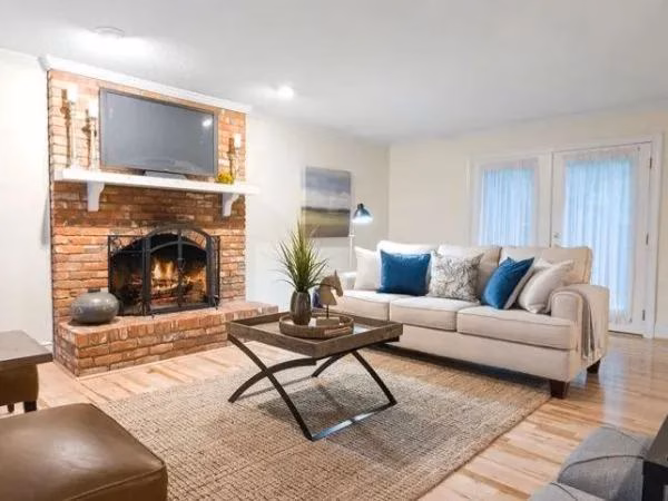 Living room picture with a brick fireplace