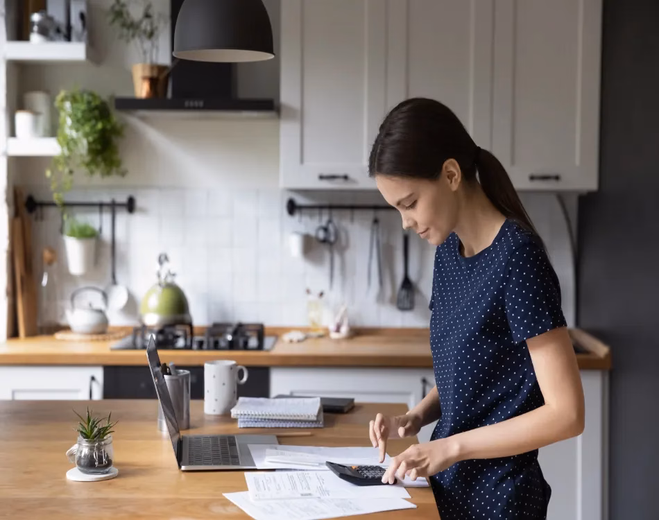 Woman use calculator calculates expenses