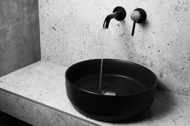 black sink and faucet with flowing water