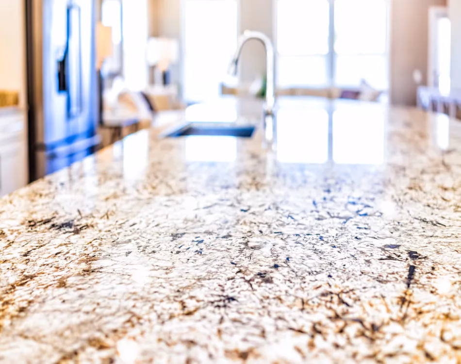 kitchen room sink closeup with island and granite countertops
